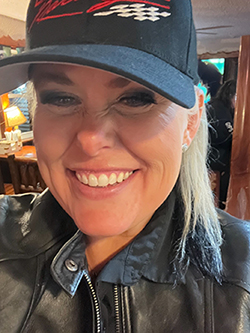 A person wearing a black hat and leather jacketDescription automatically generated