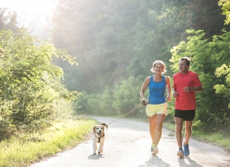 couple walking dog on a leash